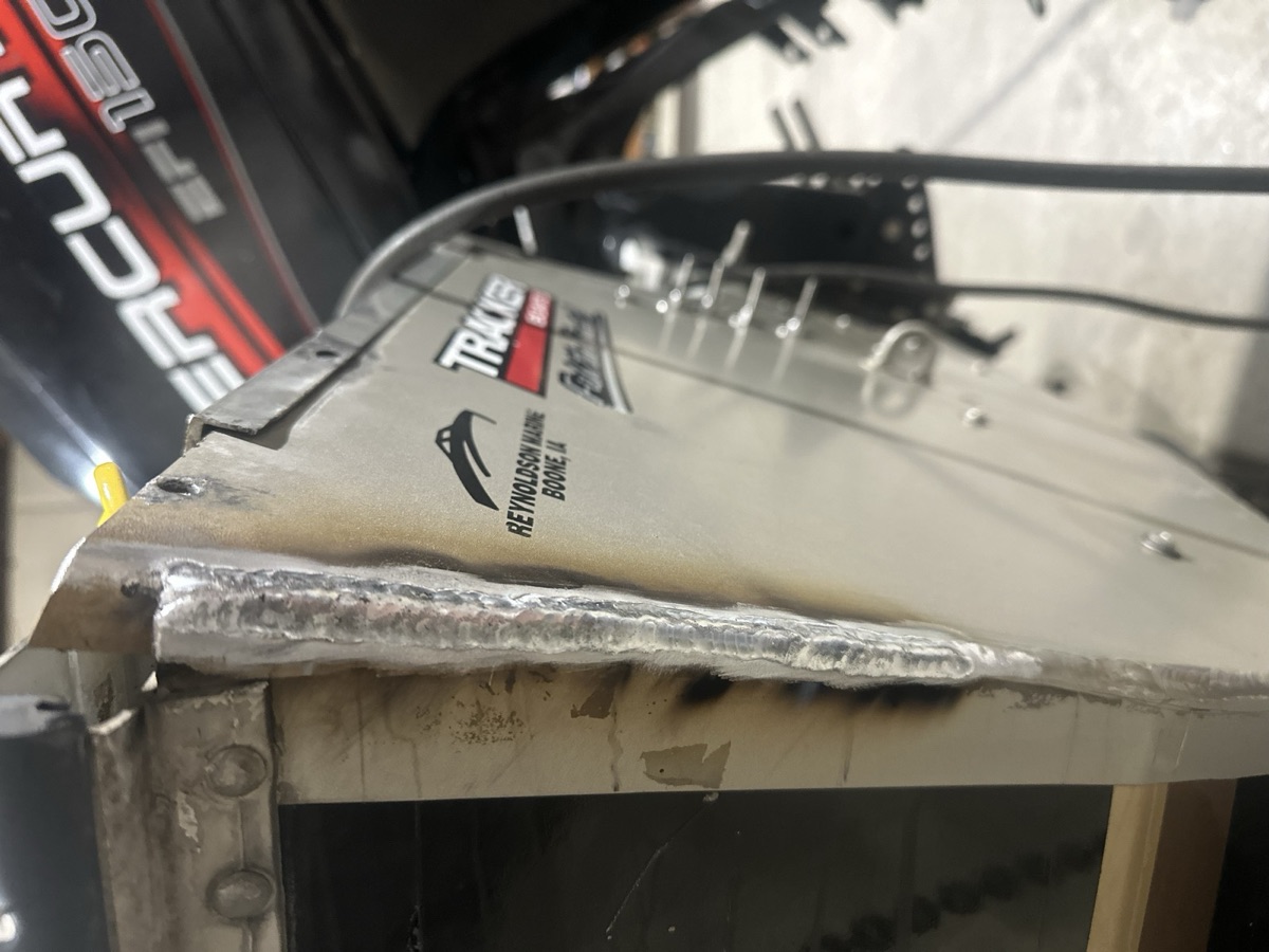 Aluminum weld repair on a Tracker boat transom in the shop