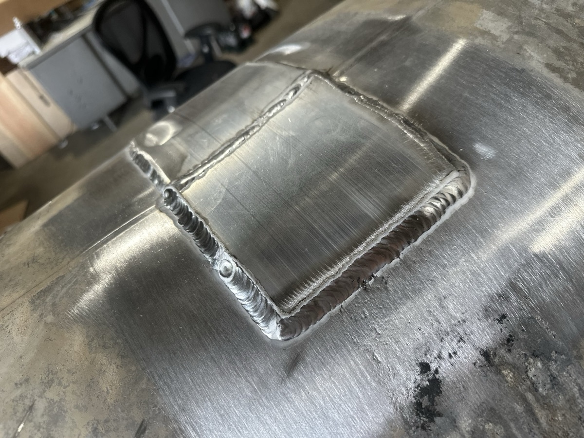 Aluminum weld patch on the surface of a large metal tank