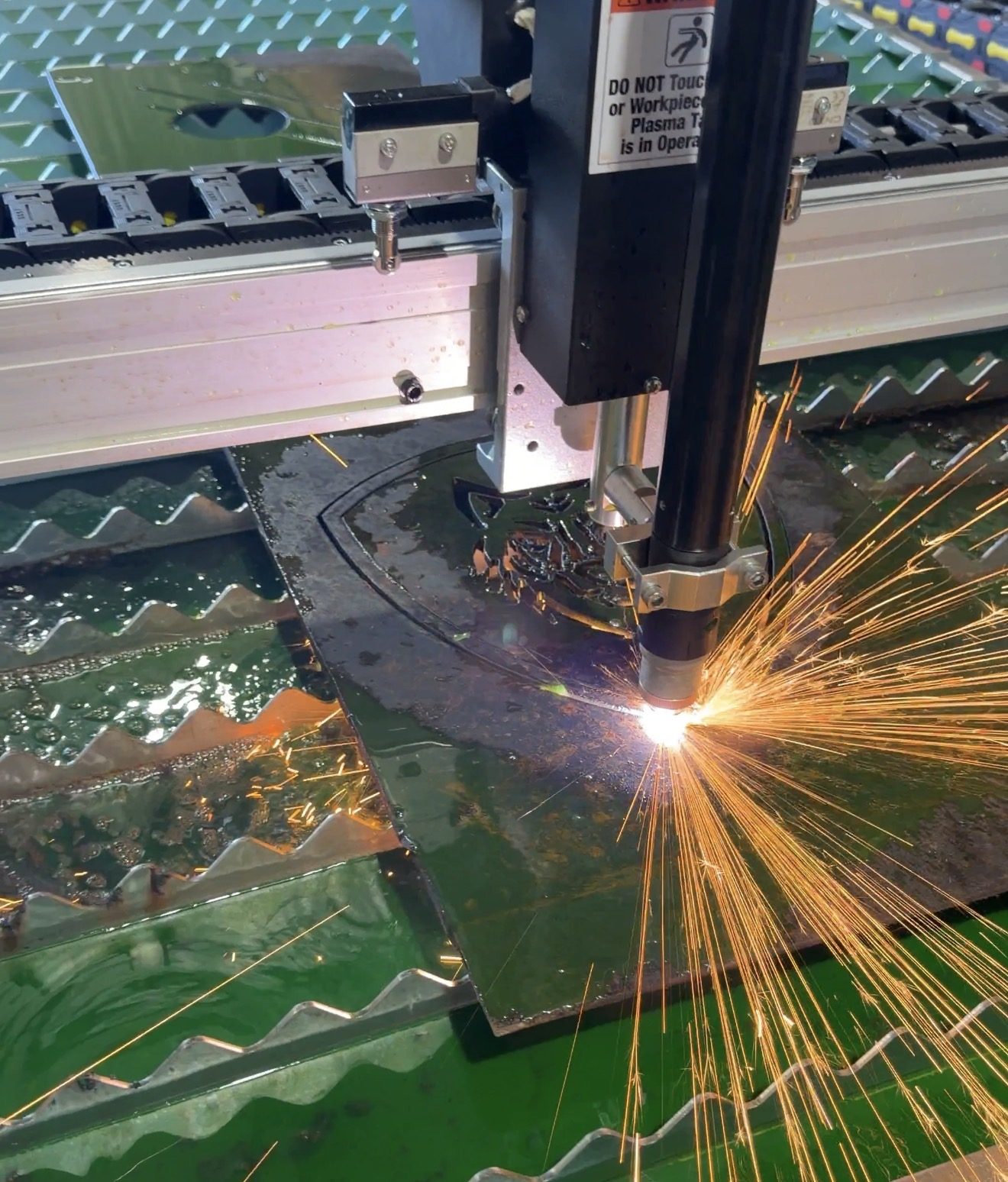 CNC plasma cutter cutting steel with sparks