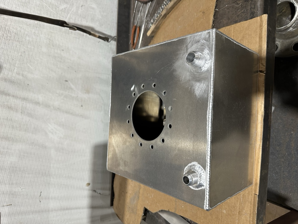 Top-down view of a custom aluminum tank with filler neck and fittings