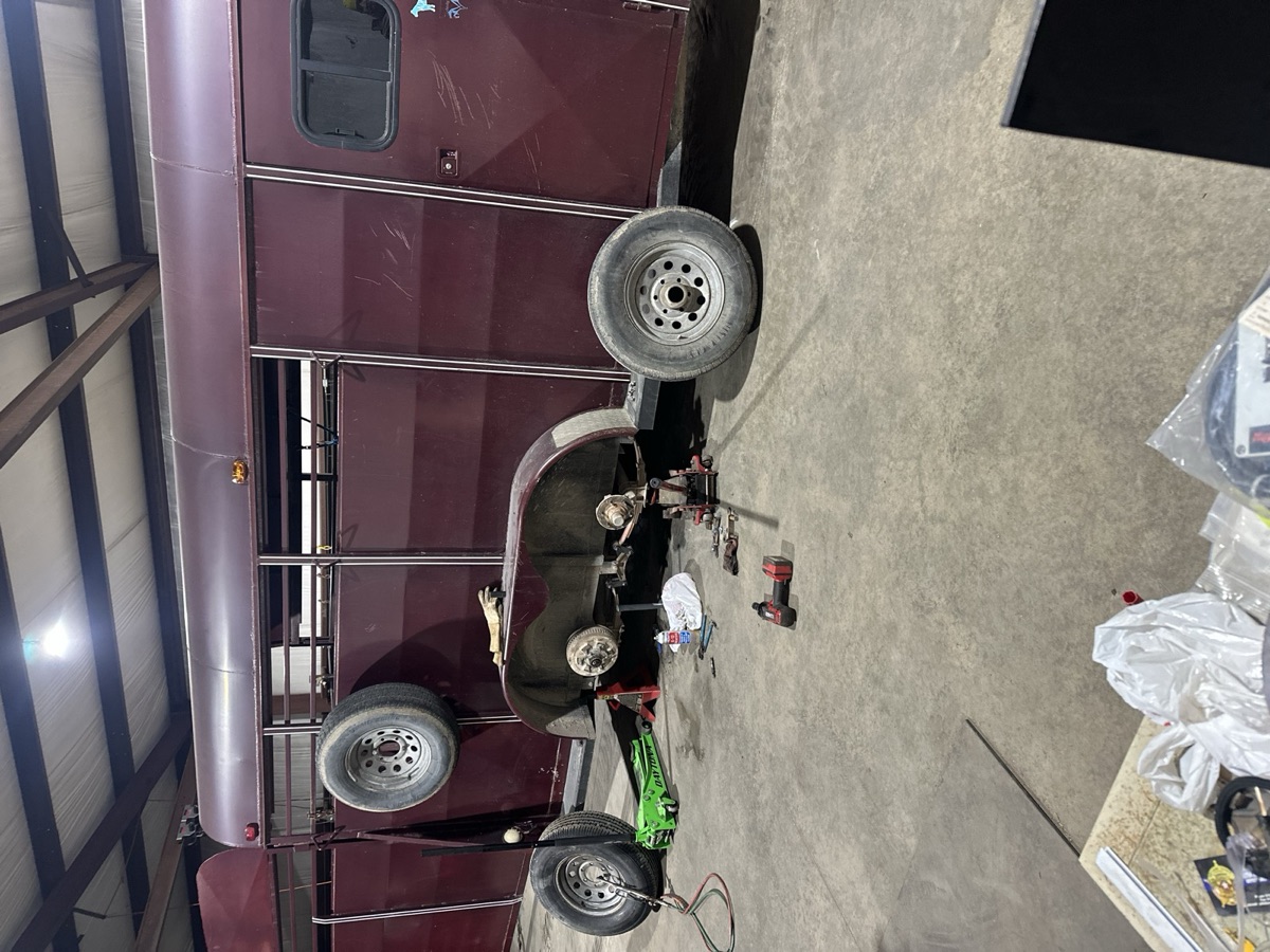 Custom-built black metal seat frame and platform sitting on gravel