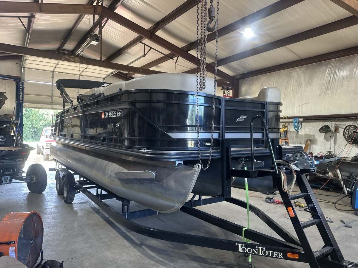 Pontoon boat on a ToonToter trailer inside the Iron Wolfe shop