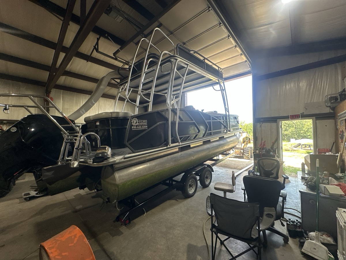 Pontoon boat on trailer inside the Iron Wolfe fabrication shop