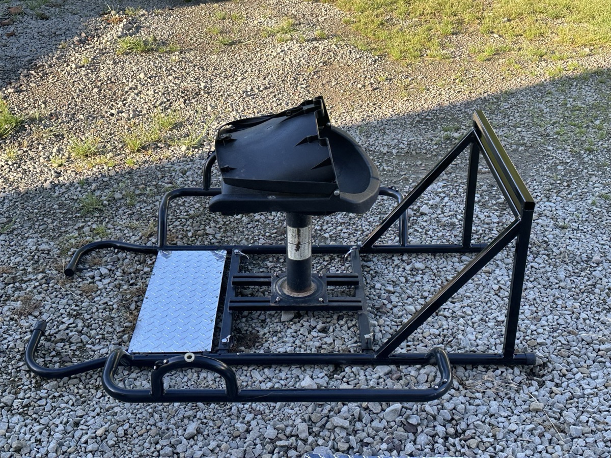 Aluminum pontoon boat on a trailer inside Iron Wolfe Welding's Eufaula shop for repair