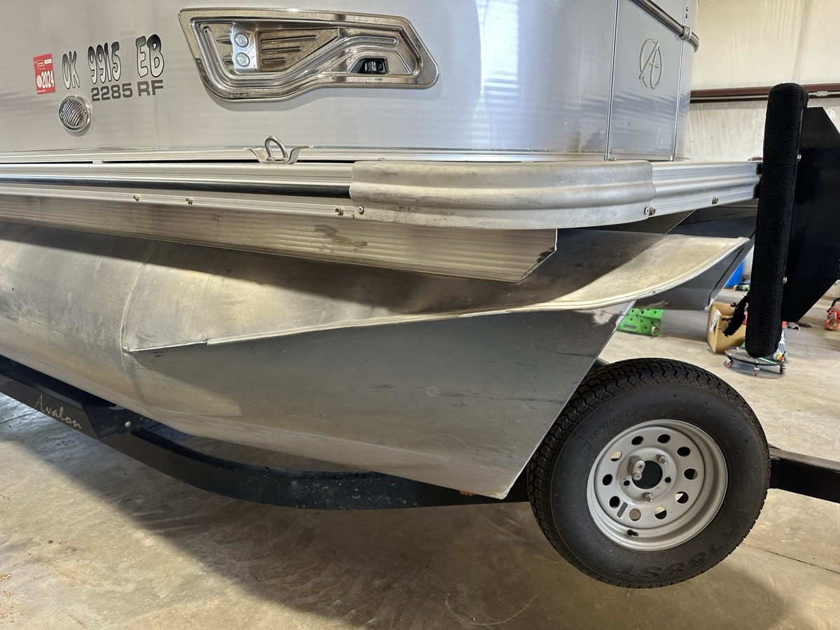 Close-up of an Avalon pontoon hull on a trailer inside the shop