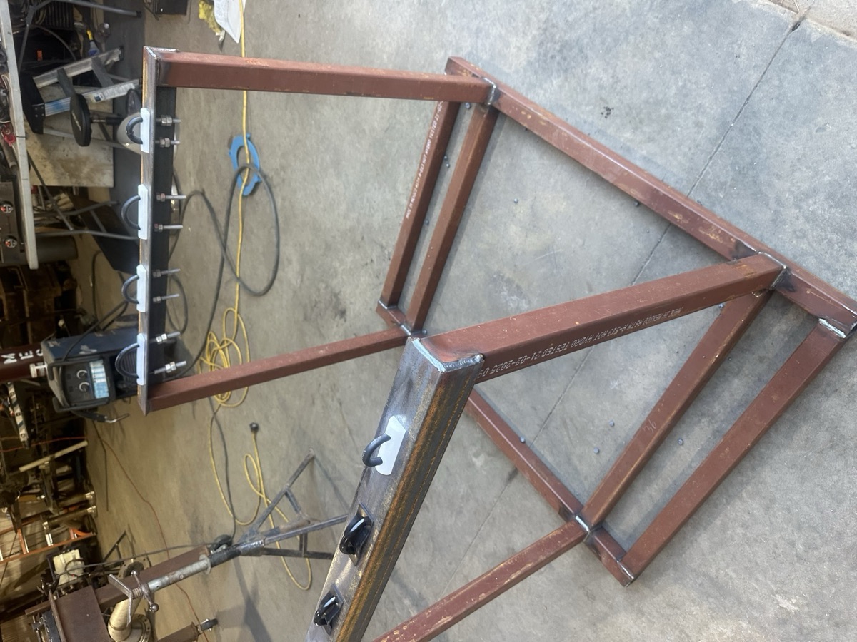 Welded steel frame project with clamps sitting on the shop floor