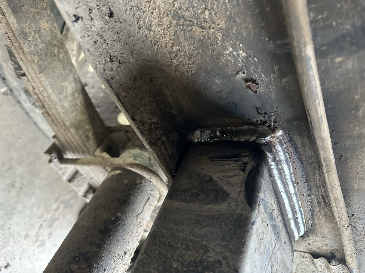 Close-up of a structural weld repair on a trailer frame