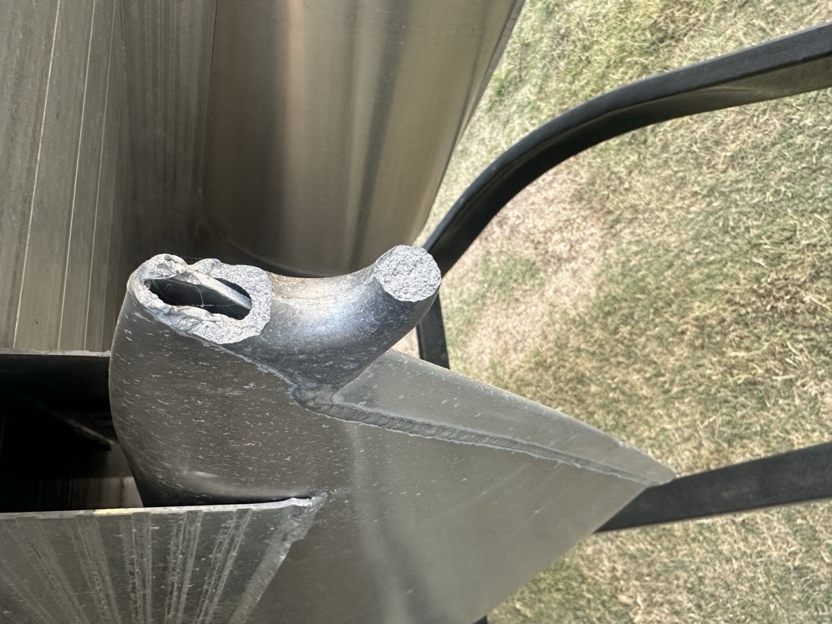 Close-up of a fabricated trailer hitch and gusset welded to a frame